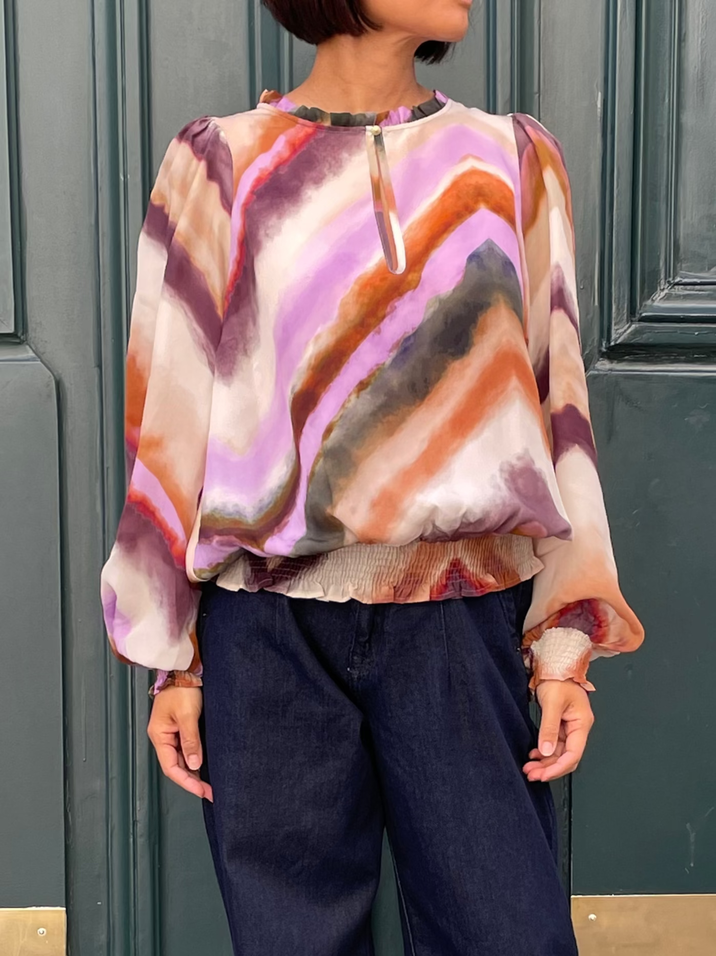 Flowing top with multicolored geometric patterns